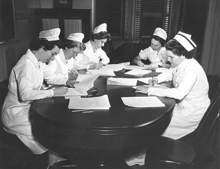 Nursing instructors grading exams in the 1950s.